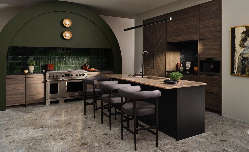 Wolf 24 Inch E Series Transitional Coffee System shown centered in a large forest green arched kitchen design with custom racing green backsplash and custom handleless wood cabinetry