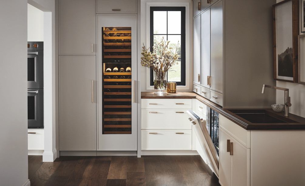 Panel ready Cove Dishwasher shown in a custom kitchen design featuring dual Wolf Ovens and Sub-Zero Wine Storage